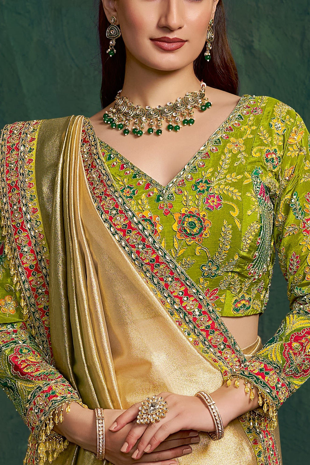Yellow green embroidered saree, upper-body closeup of the floral motif and zari work detail