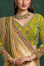 Yellow green embroidered saree, upper-body closeup of the floral motif and zari work detail