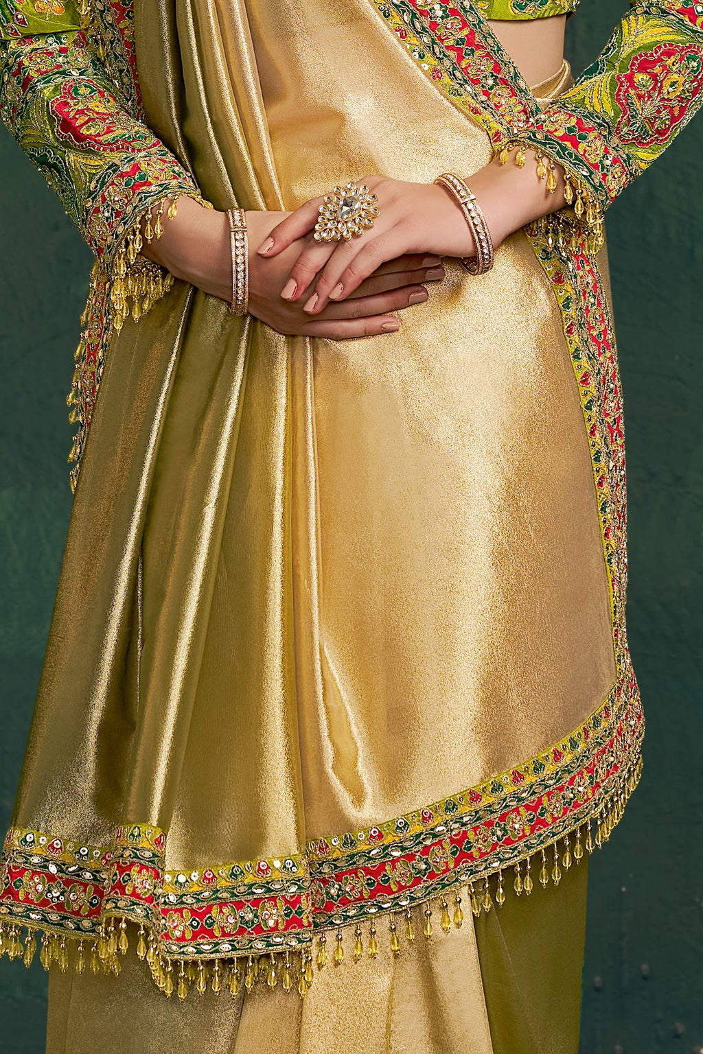Yellow green party wear saree, waist-down view of the pleats and shimmering tissue silk drape