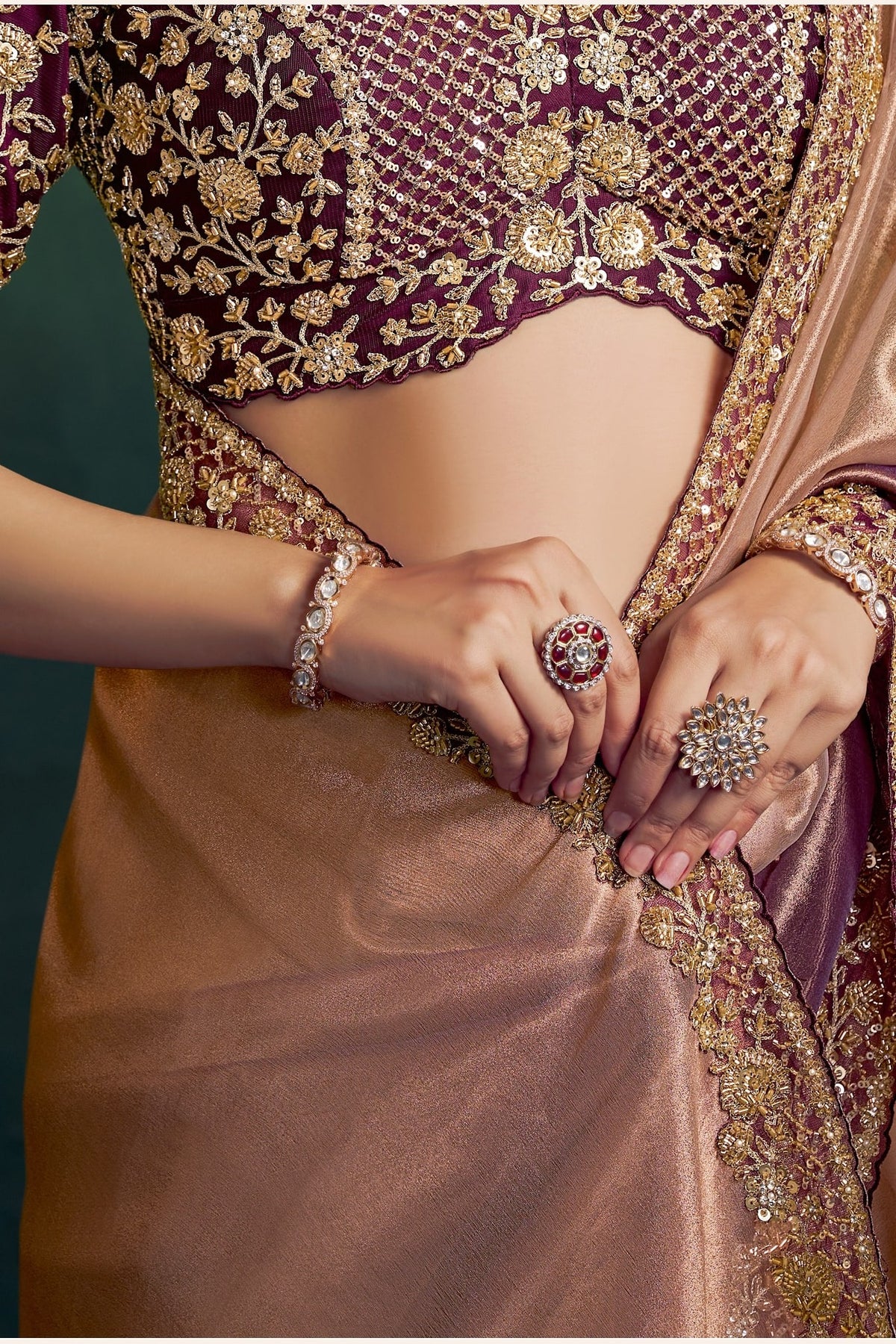 Brown saree for reception, waist-down view of the pleats and shimmering tissue silk drape