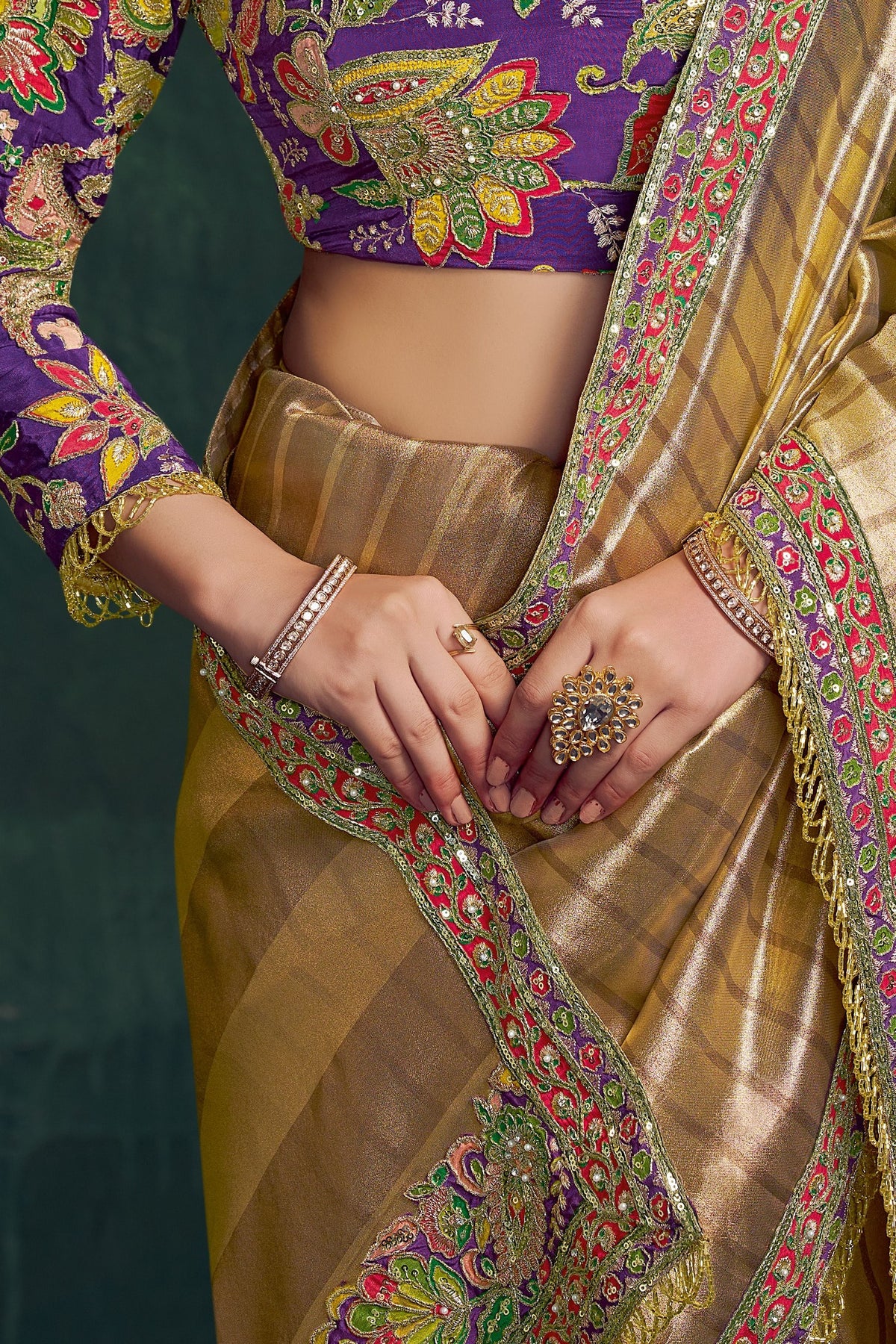 Champagne golden silk saree for wedding, waist-down view of the pleats and shimmering drape