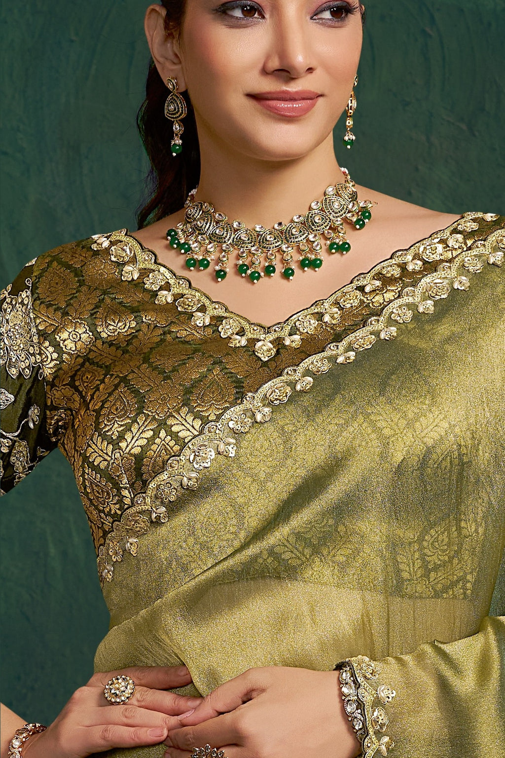 Olive green embroidered saree, upper-body closeup of the sequin embroidery and handwork detail