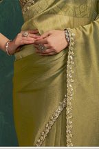 Olive green designer saree, waist-down view of the pleats and shimmering drape