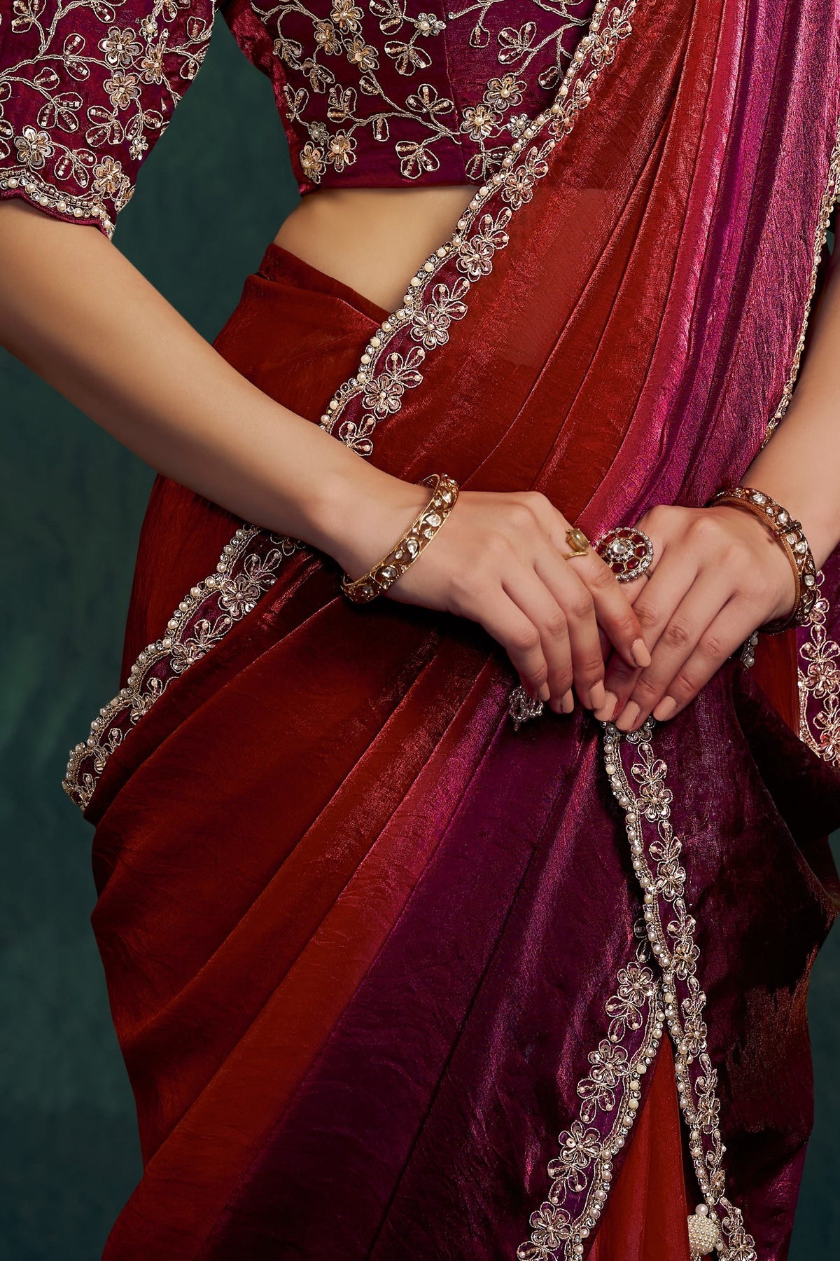 Maroon saree for reception, waist-down view of the two-tone shaded satin pleats and drape