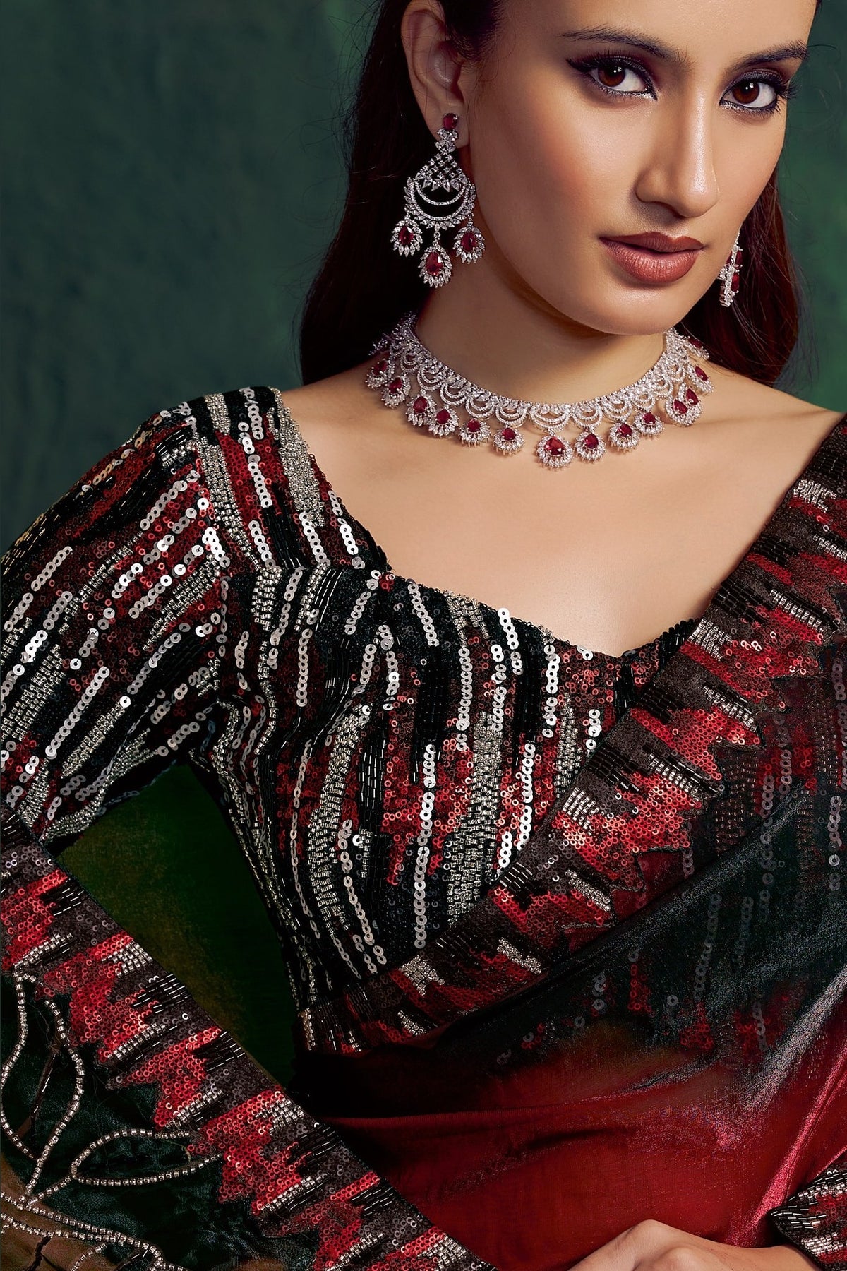 Red saree for wedding, upper-body closeup of the embellishment, bead and sequin work detail
