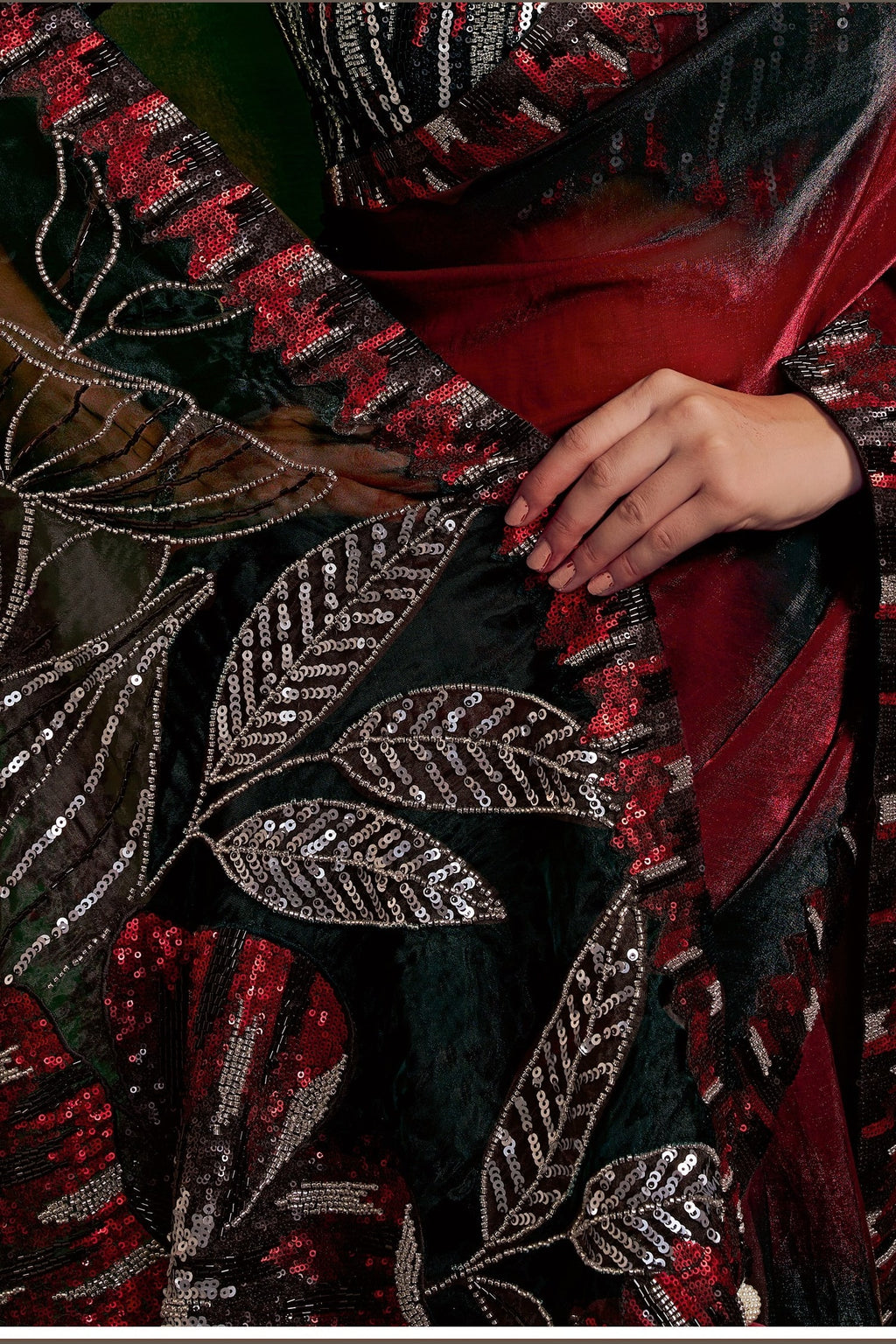 Red designer saree, waist-down view of the two-tone shaded satin pleats and drape