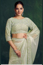 Mint green sequin saree, front view showing the handwork embellished blouse and shaded satin drape