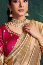 Champagne golden designer saree, upper-body closeup of the motif and bead work detail