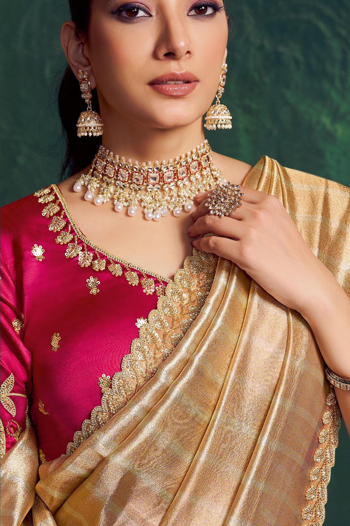 Champagne golden designer saree, upper-body closeup of the motif and bead work detail