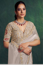 Off white embroidered saree, front view showing the embellished satin silk blouse and uppada silk drape