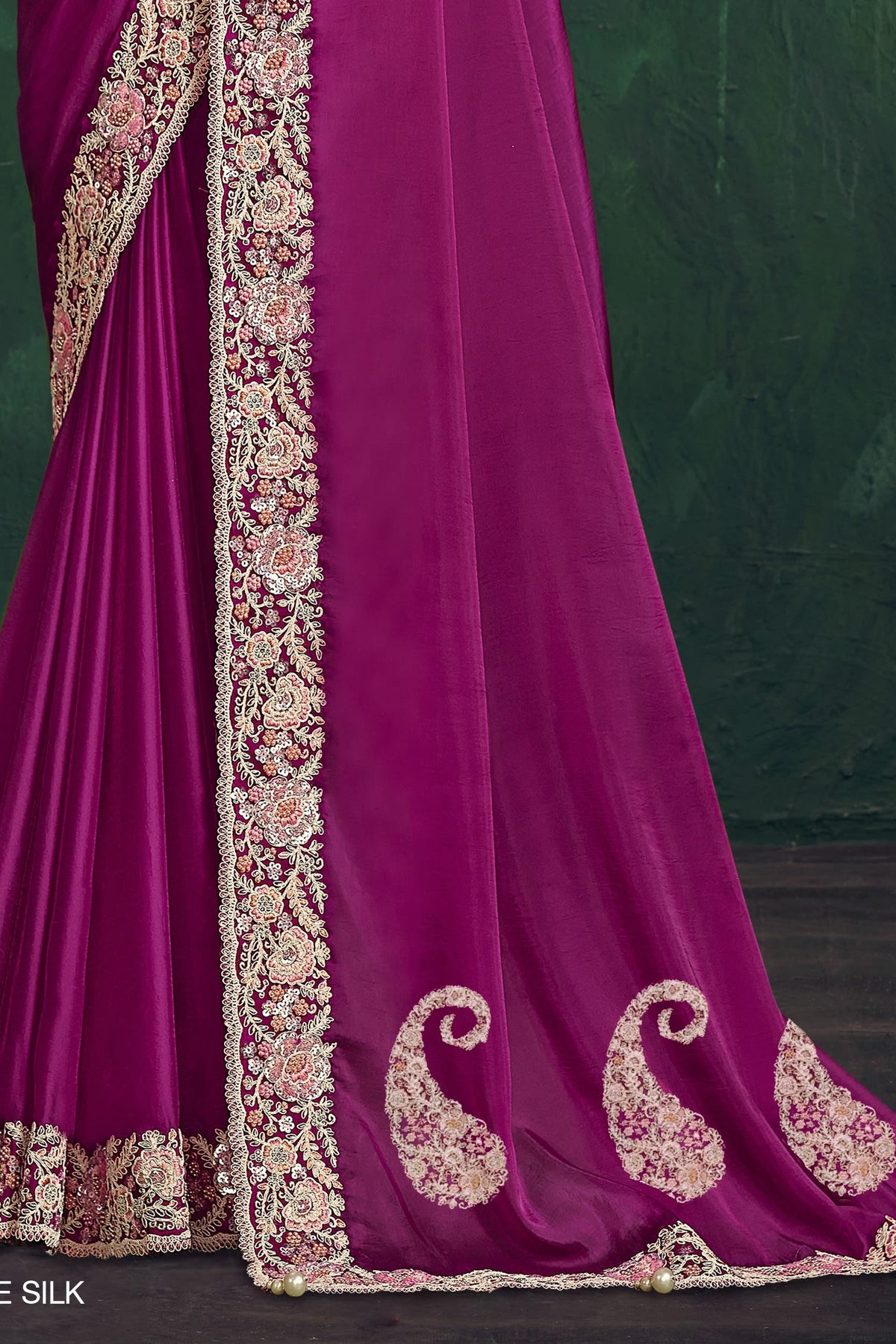 Magenta embroidered saree, waist-down view of the pleats and shimmering drape
