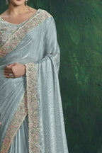 Pastel blue embroidered saree, front view showing the embellished satin silk blouse and drape