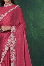 Reddish pink party wear saree, front view showing the two-tone satin silk blouse and shimmering drape