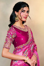 Reddish Pink wedding guest saree with thread embroidery and stone handwork, front view showing the embellished blouse and detailed border