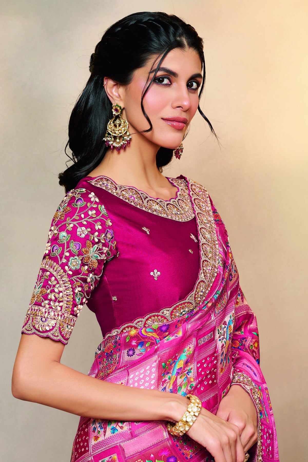 Reddish Pink wedding guest saree with thread embroidery and stone handwork, front view showing the embellished blouse and detailed border