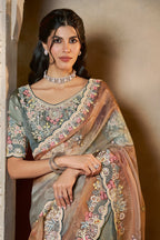 Dusty Blue organza saree with stone and thread handwork, front view showing the embellished blouse and detailed border