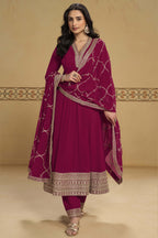 Woman wearing a reddish pink kurta for wedding in georgette with thread and sequin embroidery, georgette pant and dupatta, full-length front view.