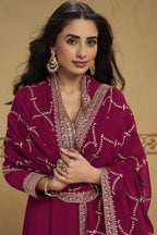 Close-up front view of a reddish pink pakistani suits style kurta in georgette with thread and sequin embroidered neckline and dupatta border.