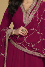 Torso detail view of a reddish pink indian salwar kameez in georgette with thread and sequin embroidery on the kurta and dupatta.