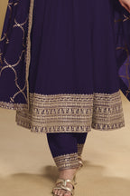 Waist-down detail view of a dark purple georgette salwar kameez with thread and sequin embroidery on the kurta hem and georgette pant.