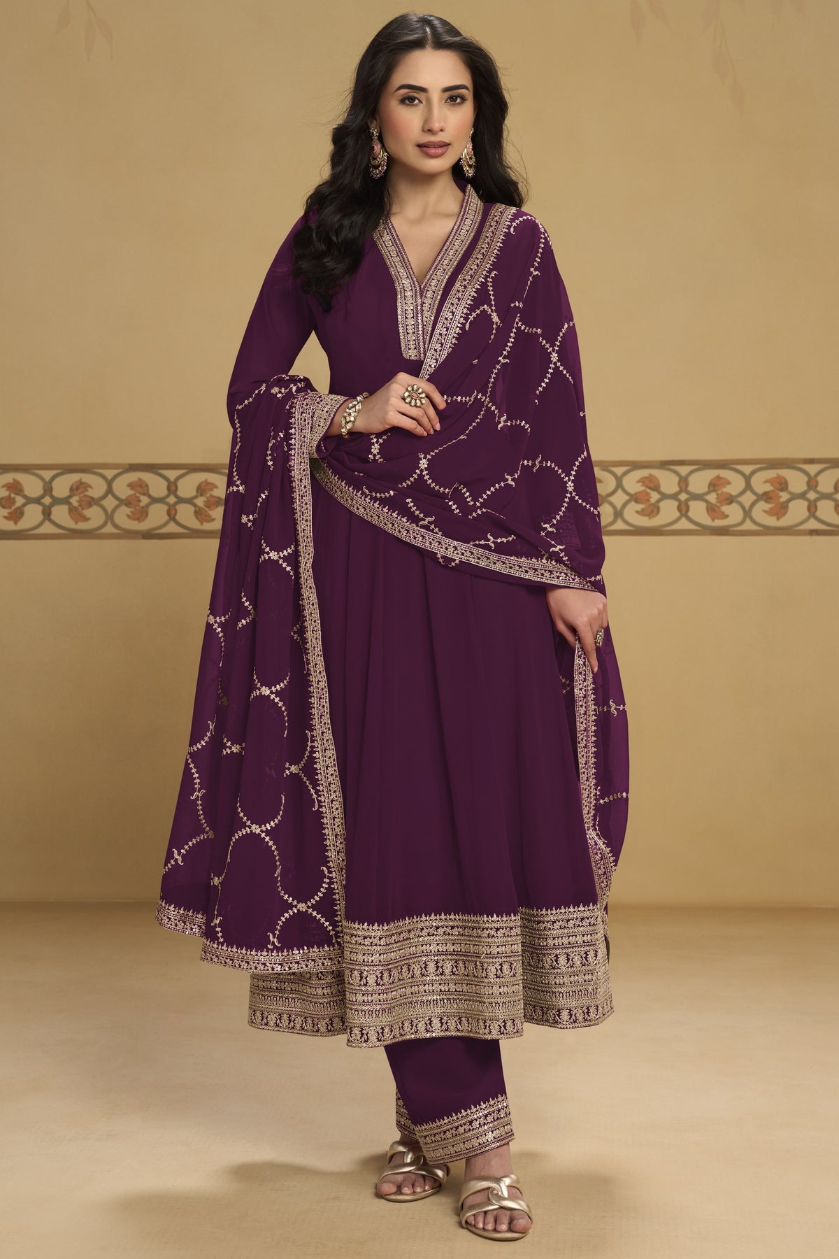 Close-up front view of a plum kurta set for women in georgette with thread and sequin embroidered neckline and embroidered dupatta border.