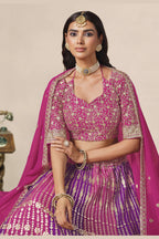 Close-up of a magenta engagement lehenga blouse in georgette with zari and sequin work on the V neckline and elbow sleeves.