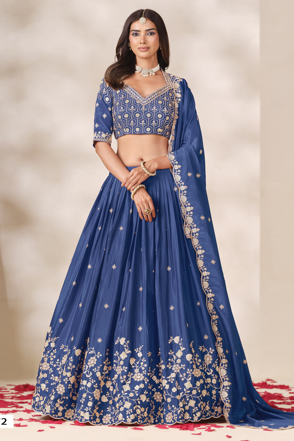 Woman wearing a dusty blue lehenga for sangeet in chinon silk with sequin and thread embroidery, embroidered blouse and dupatta, full-length front view.