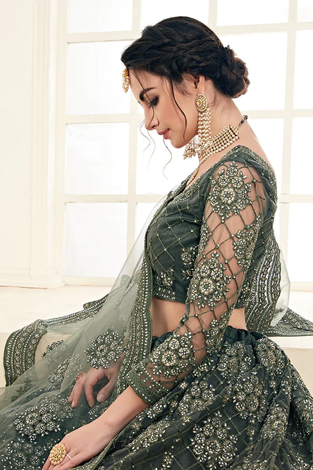 Woman wearing mahendi net lehenga choli with dupatta for Indian wedding