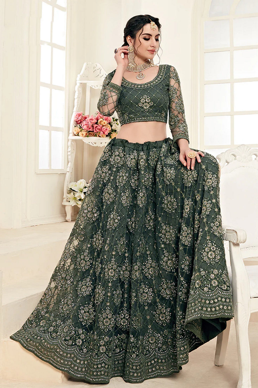 Close-up of codding and badla embroidery work on mahendi net lehenga choli