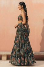 Woman wearing a floral dress against a pink wall