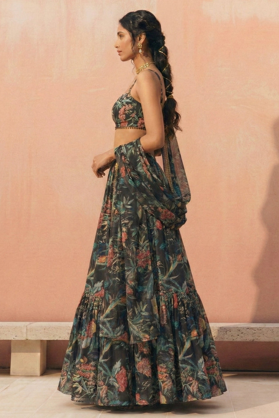 Woman wearing a floral dress against a pink wall