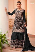 Woman wearing a black plazo dress in chinon silk with thread embroidery work, paired with an embroidered plazo and dupatta, full-length front view.