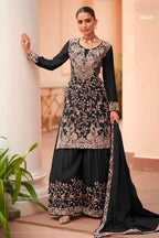 Woman wearing a black plazo dress in chinon silk with thread embroidery work, paired with an embroidered plazo and dupatta, full-length front view.