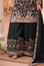 Waist-down detail view of a black palazzo dress in chinon silk with thread embroidery work on the plazo hem and dupatta border.