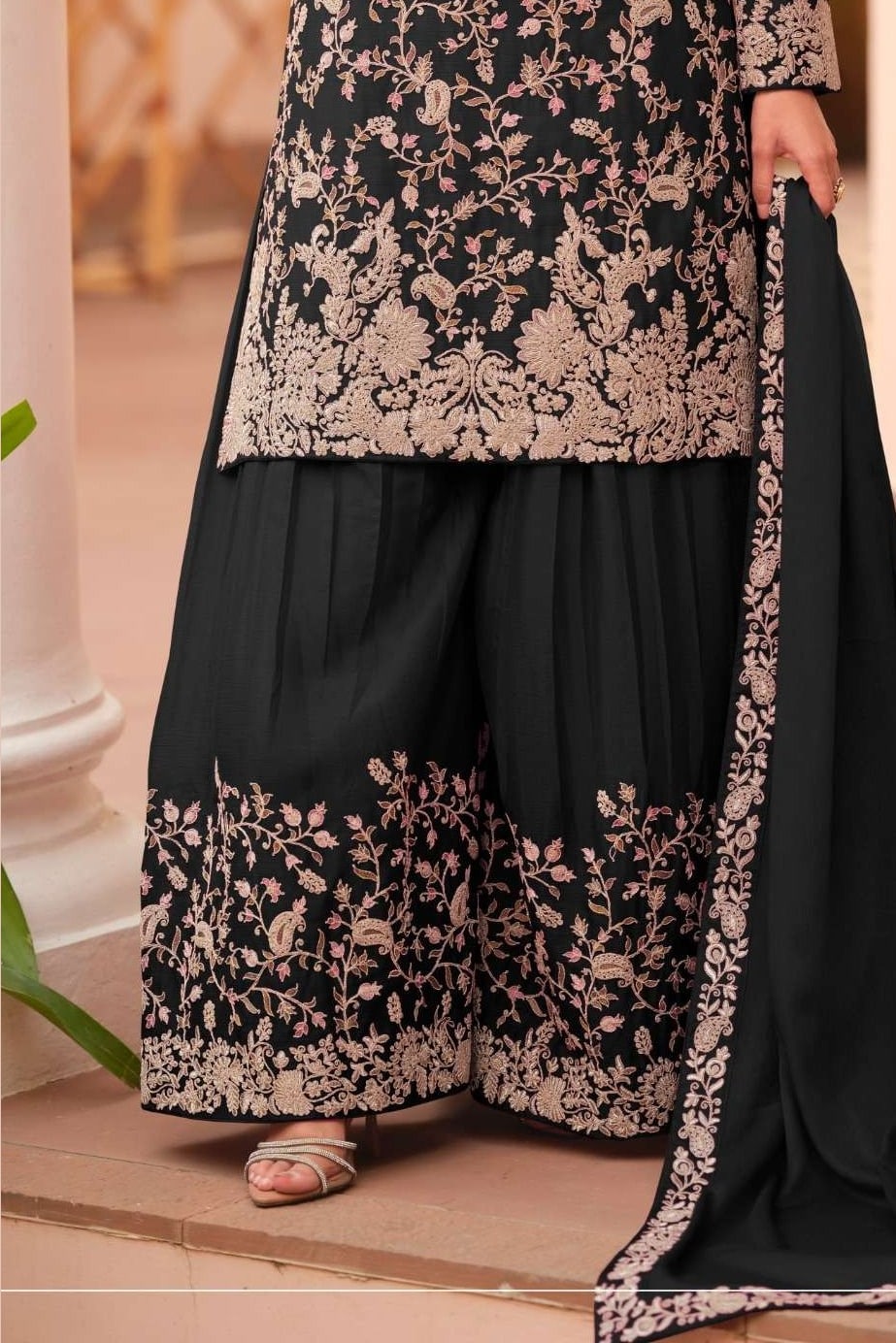 Waist-down detail view of a black palazzo dress in chinon silk with thread embroidery work on the plazo hem and dupatta border.