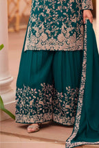 Waist-down detail view of a teal palazzo suit for women in chinon silk with thread embroidery work on the plazo hem and dupatta border.