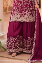 Waist-down detail view of a maroon palazzo suit for women in chinon silk with thread embroidery work on the plazo hem and dupatta border.