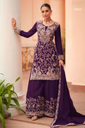 Woman wearing a dark purple palazzo suit for women in chinon silk with thread embroidery work, paired with an embroidered plazo and dupatta, full-length front view.