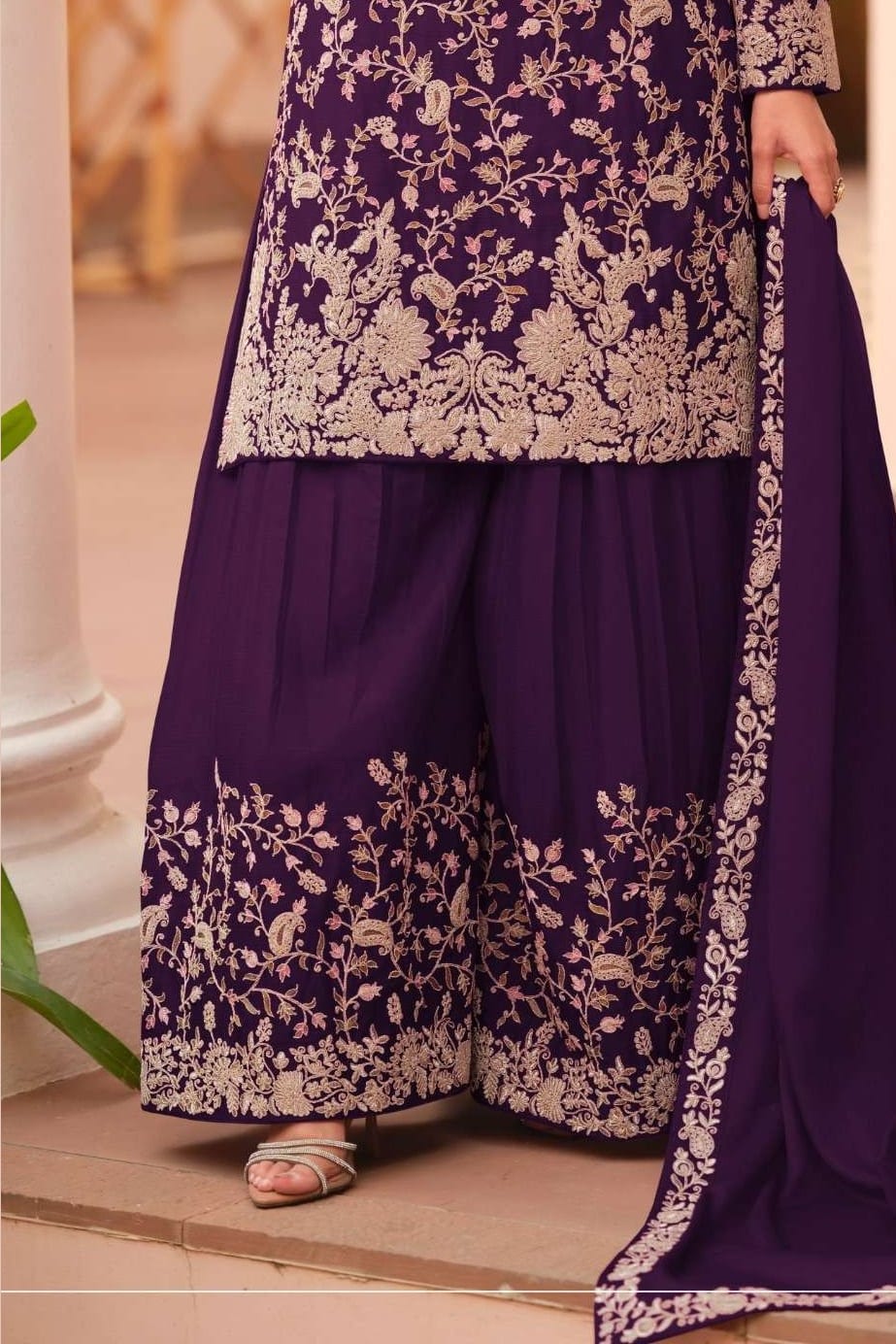 Waist-down detail view of a dark purple palazzo dress in chinon silk with thread embroidery work on the plazo hem and dupatta border.