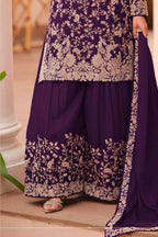 Waist-down detail view of a dark purple palazzo dress in chinon silk with thread embroidery work on the plazo hem and dupatta border.