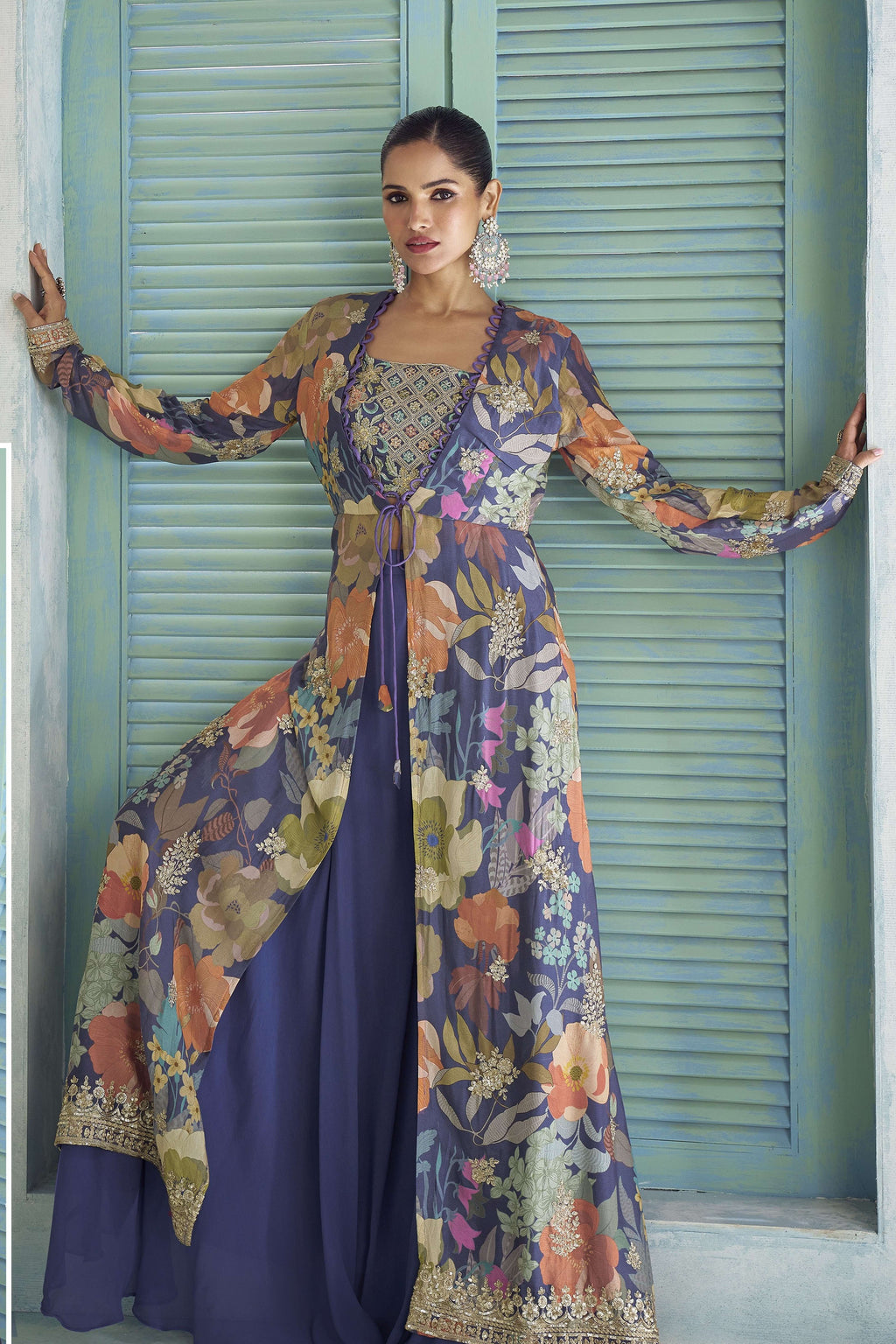 Purple palazzo suit with floral print jacket worn open over a round neckline embroidered blouse.