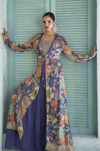 Purple palazzo suit with floral print jacket worn open over a round neckline embroidered blouse.