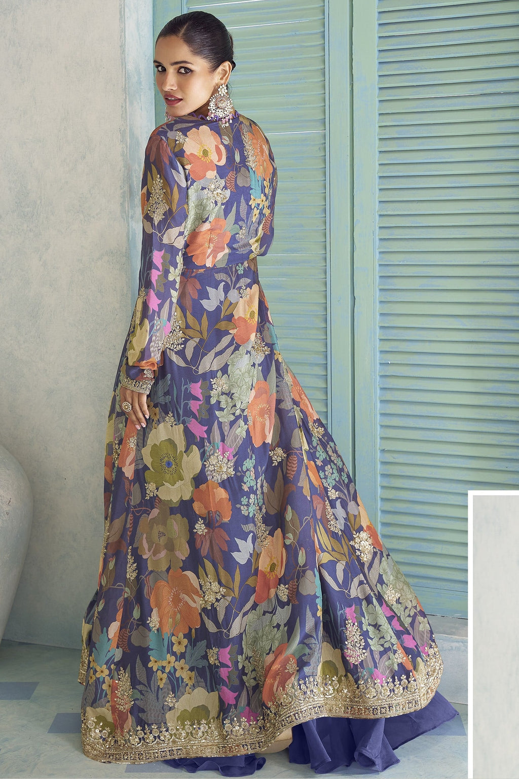 Back view of the purple palazzo suit, showing the flowing floral jacket and embroidered hem.