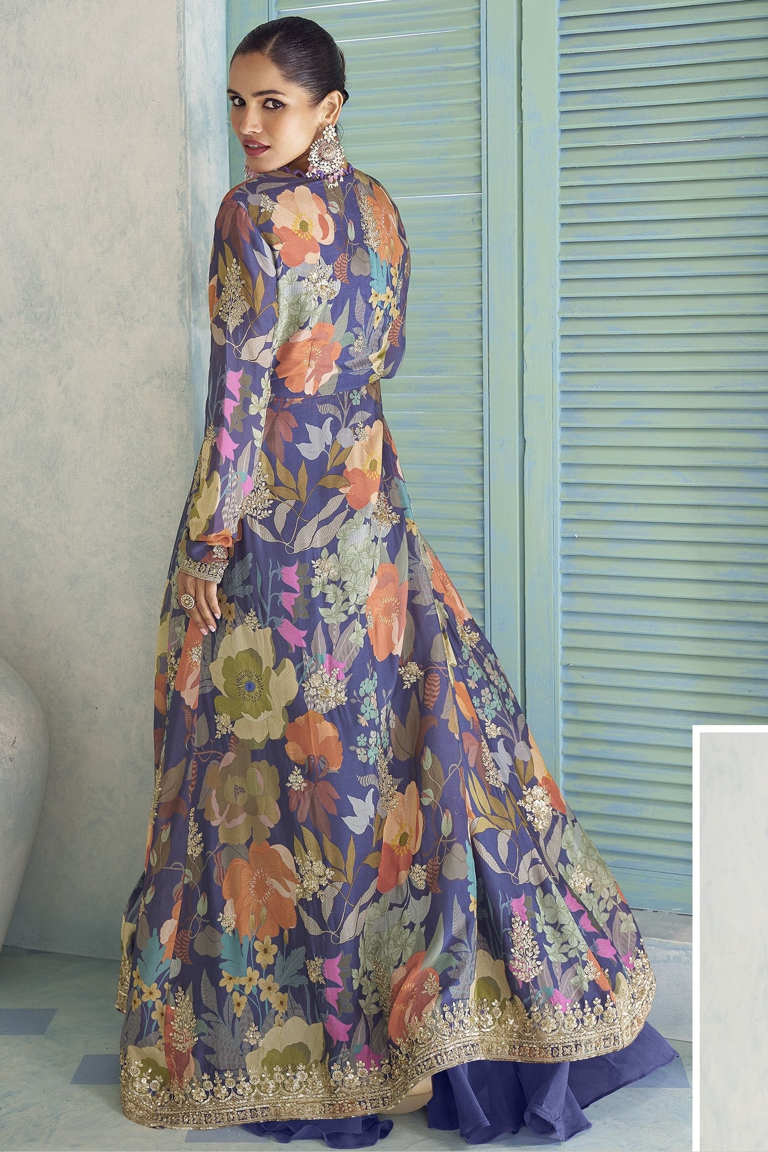 Back view of the purple palazzo suit, showing the flowing floral jacket and embroidered hem.