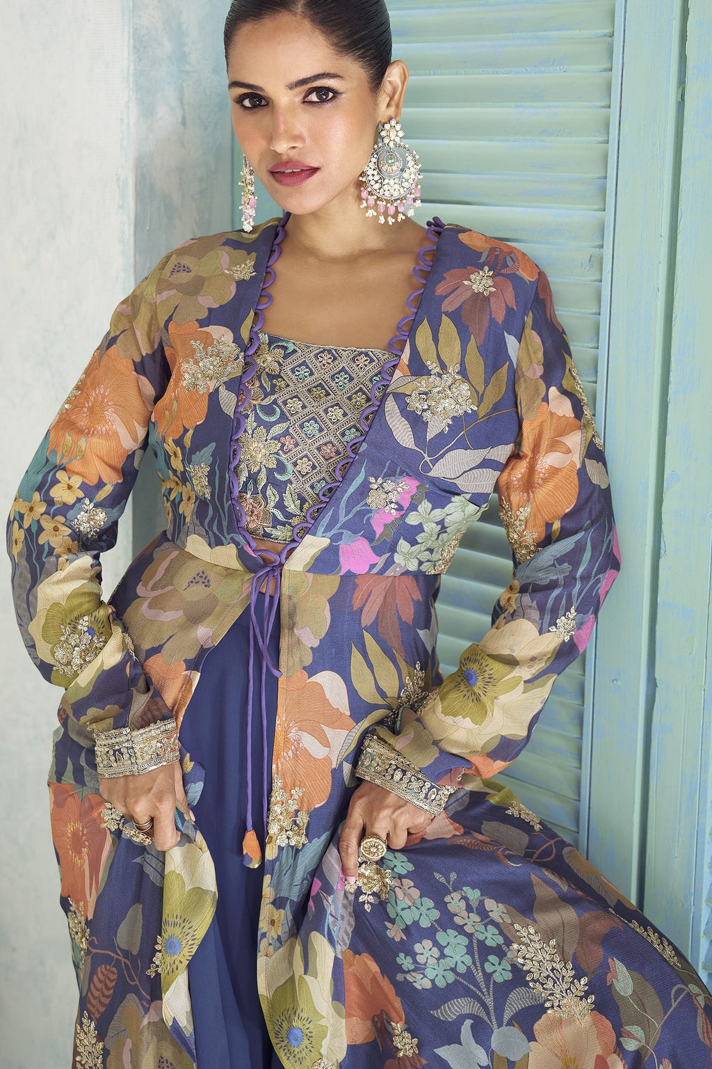 Close-up of the purple palazzo suit's embroidered blouse and floral print jacket detailing.