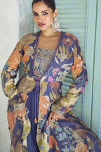 Close-up of the purple palazzo suit's embroidered blouse and floral print jacket detailing.
