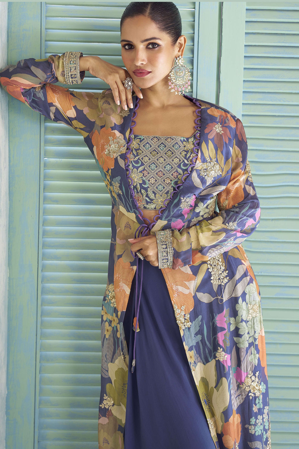 Detail shot of the purple palazzo suit's chinon silk floral print and thread embroidery.