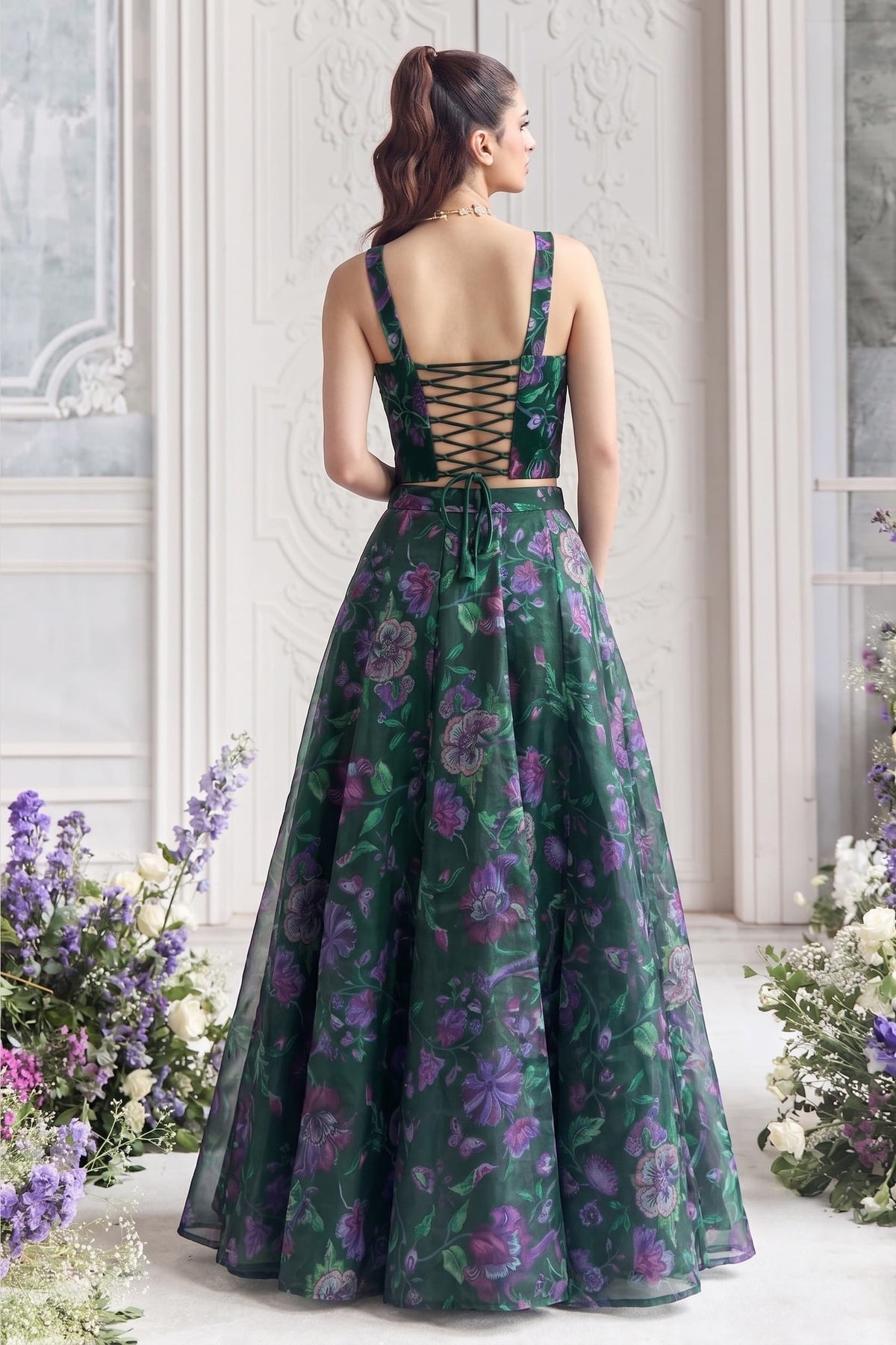 Back view of the bottle green lehenga choli, showing its deep neckline and delicate lace-up tie detailing.