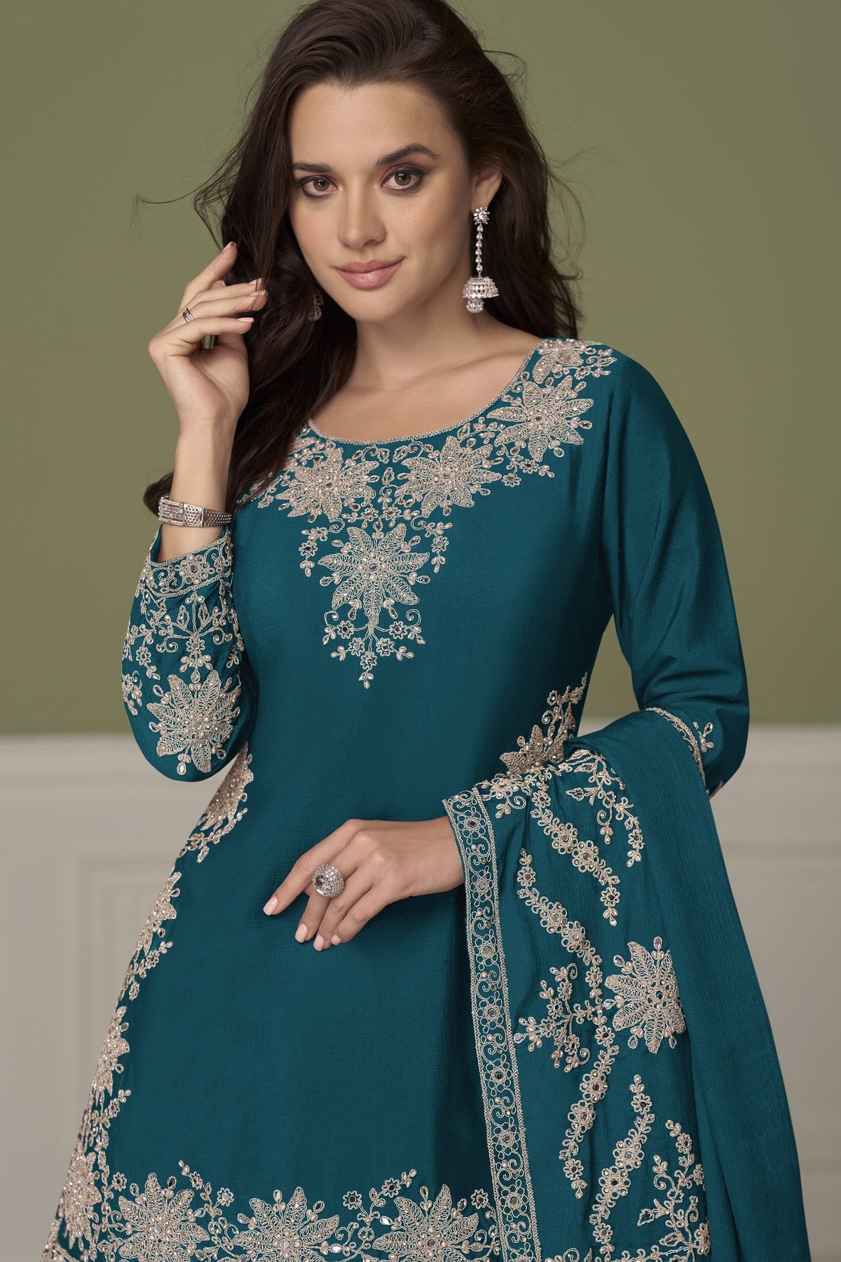 Dark teal kurta set for women, waist-down view showing embroidered skirt with mirror and moti work.