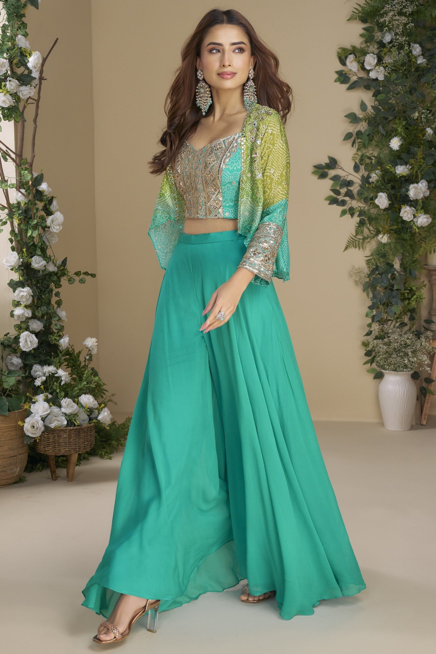 Woman wearing a teal traditional outfit with a floral background